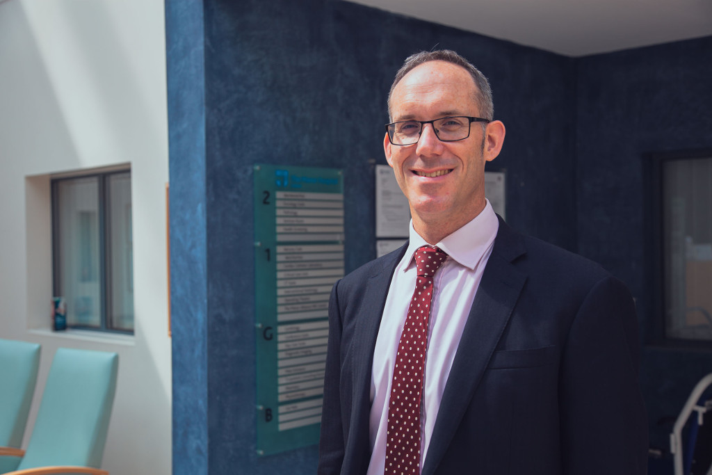 Sinclair smiling in hospital reception area